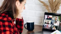 Woman attending an online meeting from home