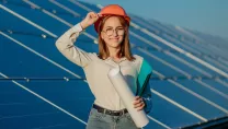 Woman stood in front on solar panels