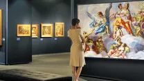 A woman looking at an 8K screen in a museum