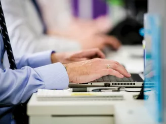 Close up of hands typing on a keyboard