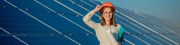 Woman stood in front on solar panels