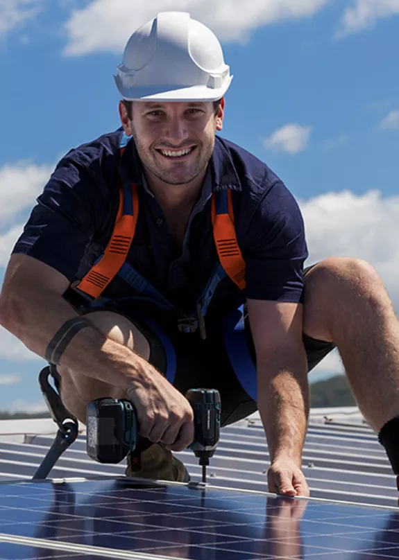 PV installer working on a roof installing solar panels