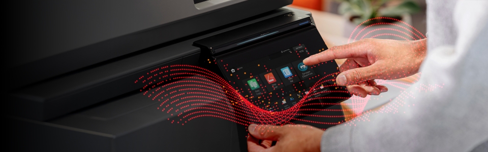 A close up of a man using the Synappx Cloud Print software installed on a printer